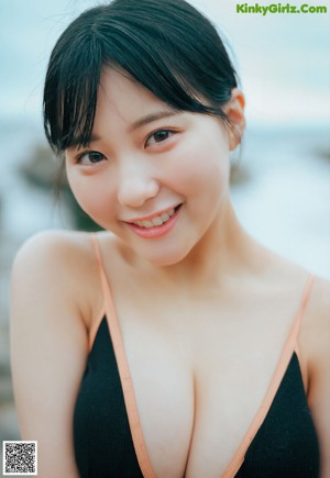 A woman in a bikini standing on a beach.