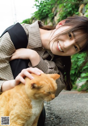 A woman with long black hair is posing for a picture.