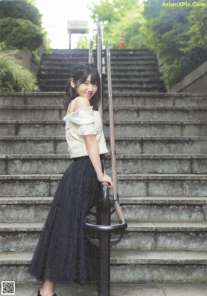 A young woman with long black hair and bangs.