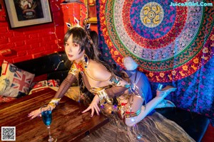 A woman dressed in a costume sitting on a table.