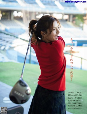 A woman in a green dress posing for a magazine.