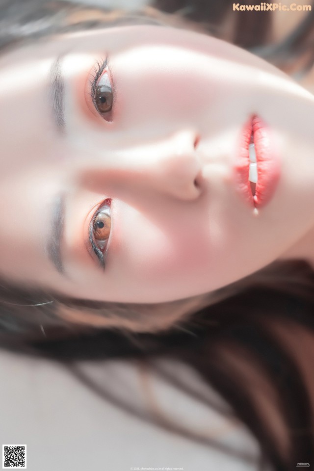 A close up of a woman's face with long black hair.