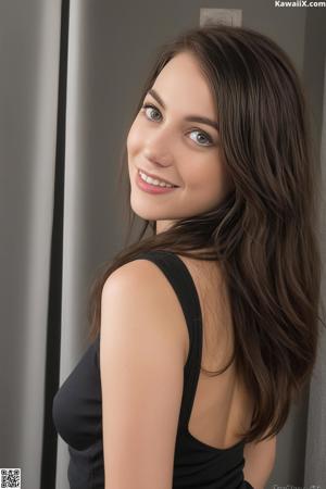 A woman in a black dress posing for a picture.