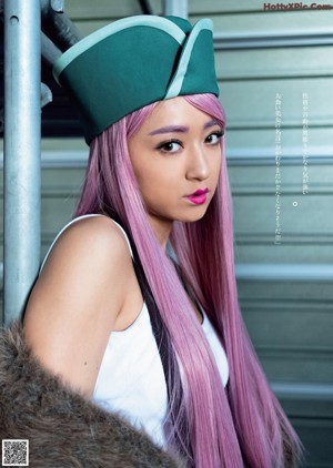 A woman in a pink hat and purple shorts posing for a magazine.
