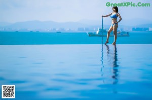 A woman standing on the deck of a boat in the ocean.