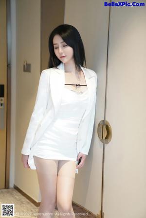 a woman in a black bra and panties standing in front of a mirror