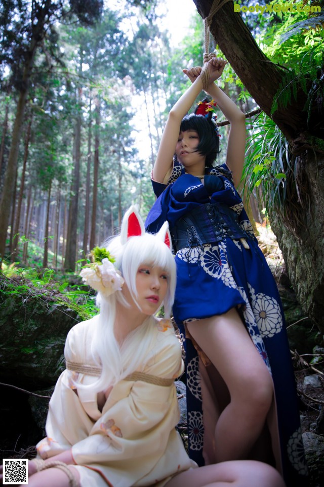 A couple of women in kimonos sitting next to each other.