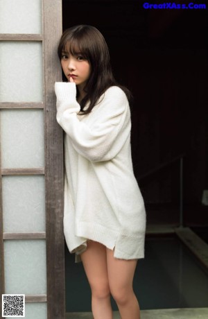 A woman in a white towel is posing for a picture.